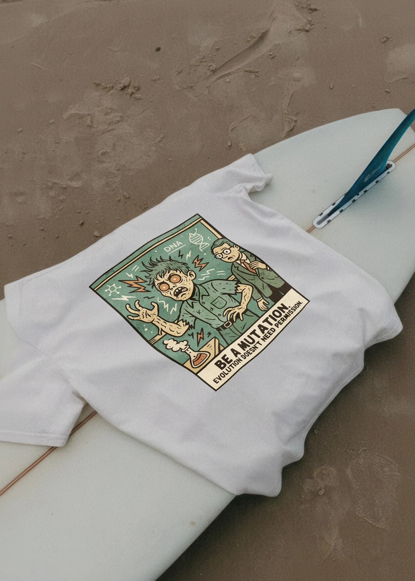 White sweatshirt with a colorful graphic design on a sandy surface