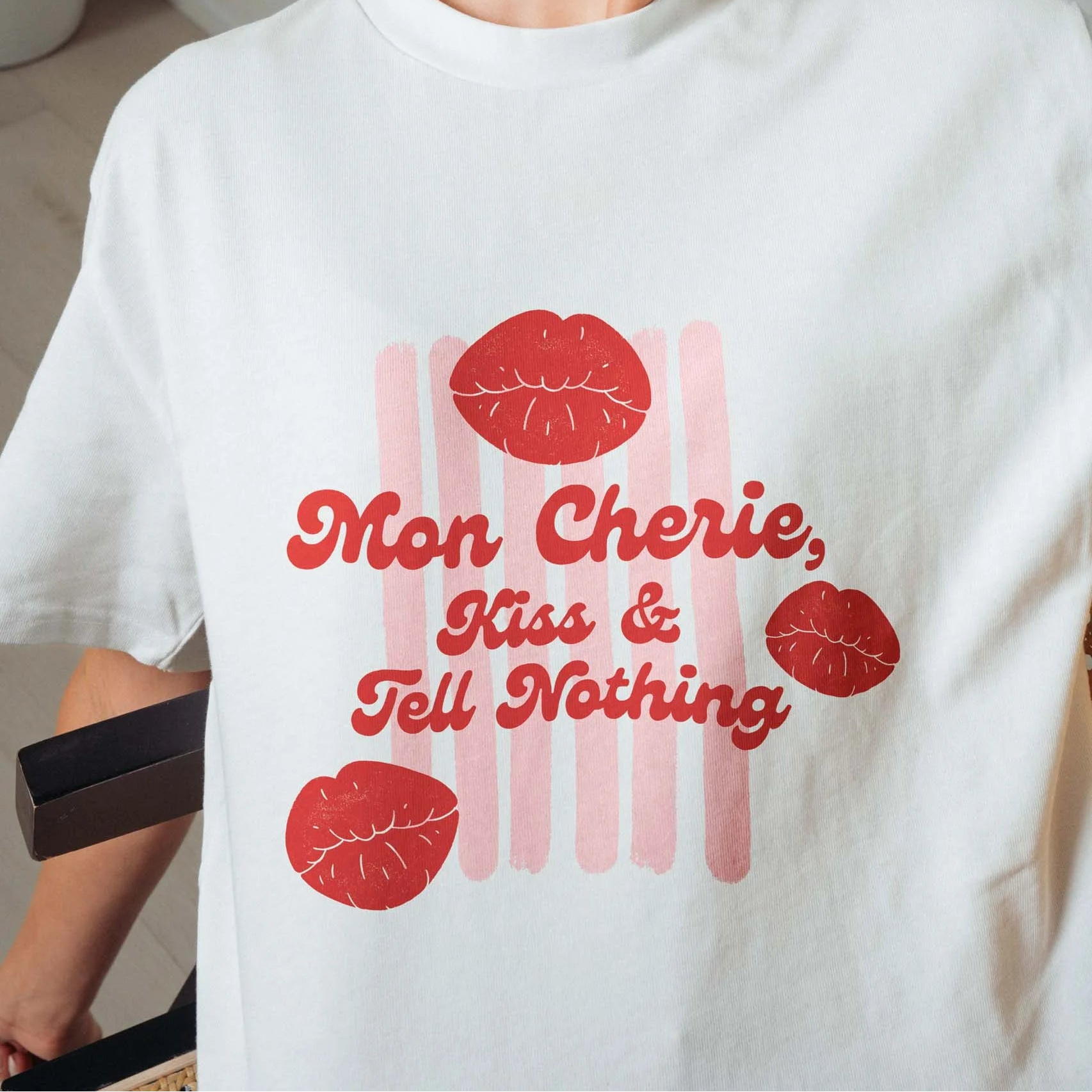 Woman wearing a white t-shirt with red text and graphics