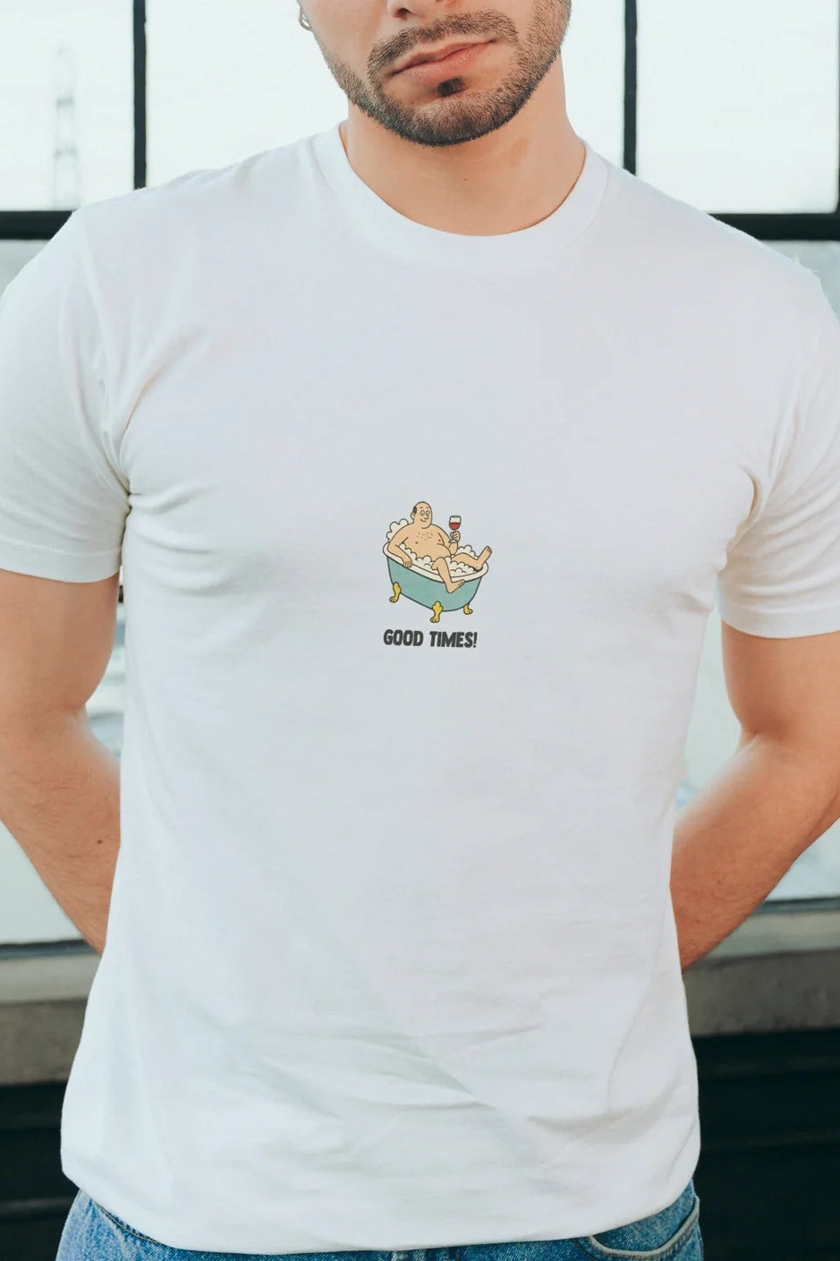 Person wearing a white t-shirt with a graphic design and text "GOOD TIMES"