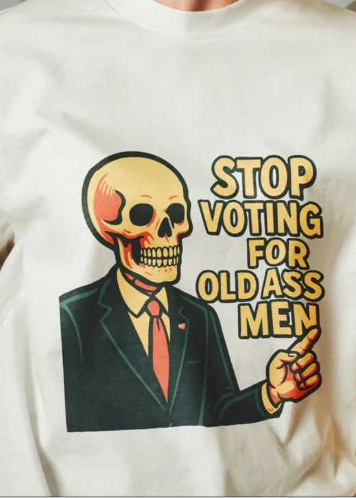 Sweatshirt with a graphic of a skeleton in a suit and tie, holding a finger to the side, with text 'Stop Voting for Old Ass Men' on a white background.