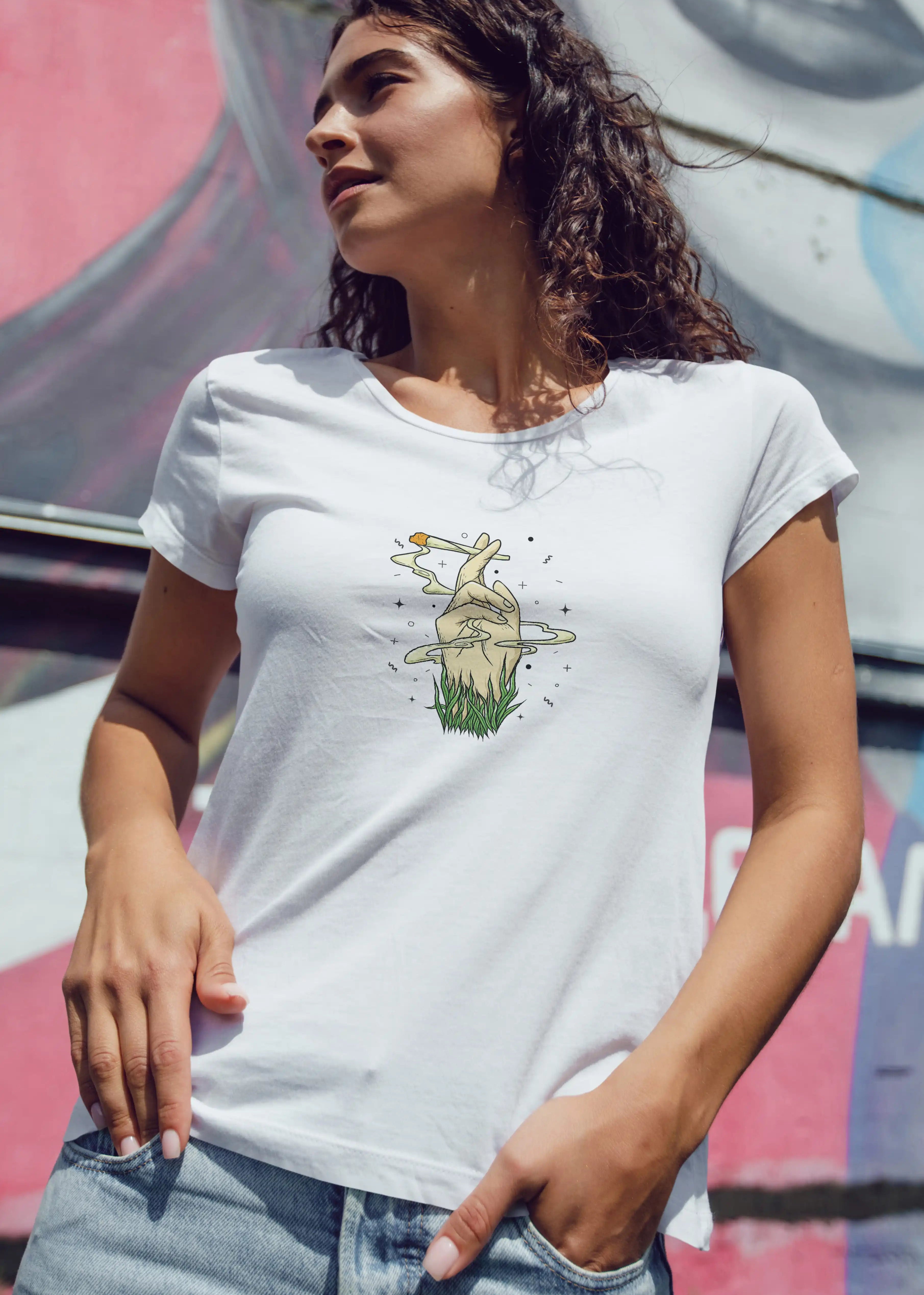 Woman wearing a white t-shirt with a graphic design, standing against a colorful background.